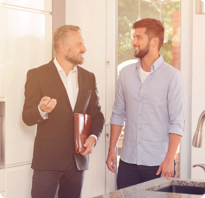 A lettings agent showing a landlord around a property