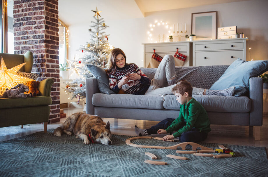 Family sat in the living room with surrounding Christmas decorations and toys