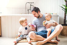 Father in the bathroom with his children brushing their teeth