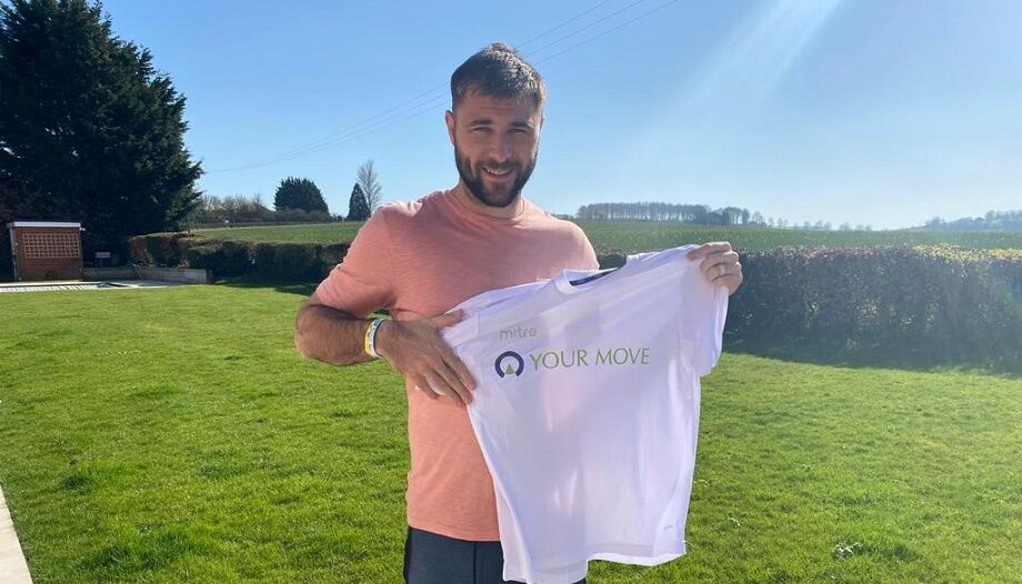 Charlie Austin holding Your Move football jersey