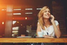 Lady on the phone whilst in a cafe