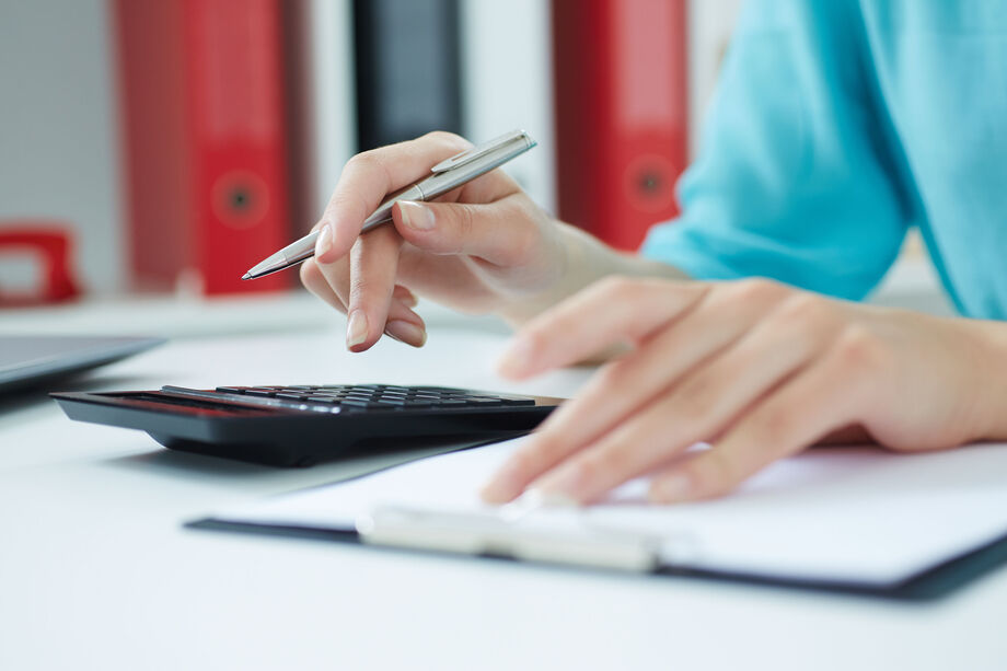 Person at a desk calculating numbers