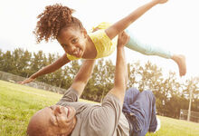 Person holding up a child above their head