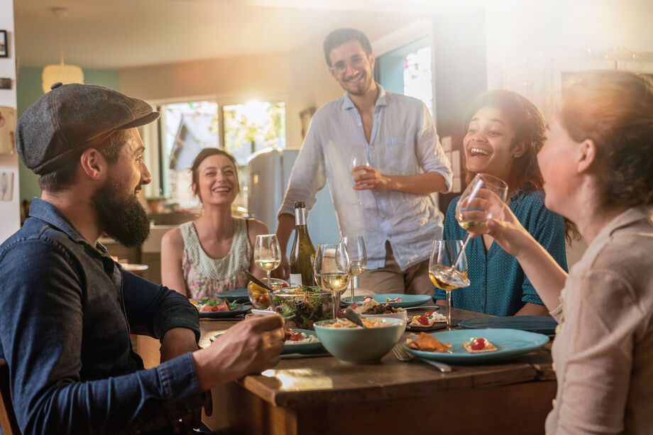 People sat around a table eating and drinking