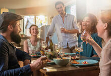 People sat around a table eating and drinking