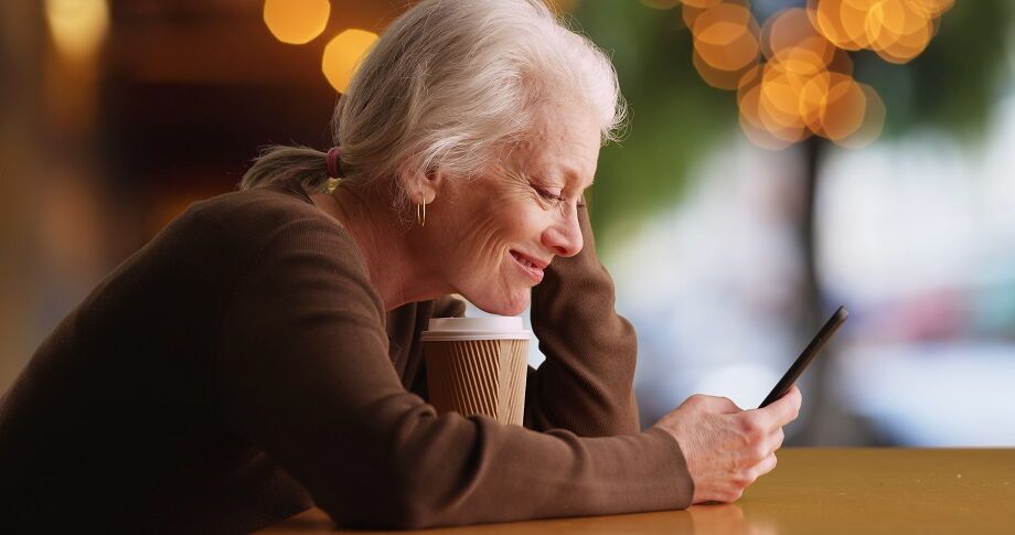 person smiling at phone