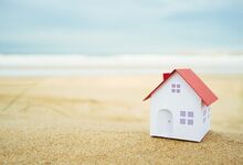 Minature house on a beach