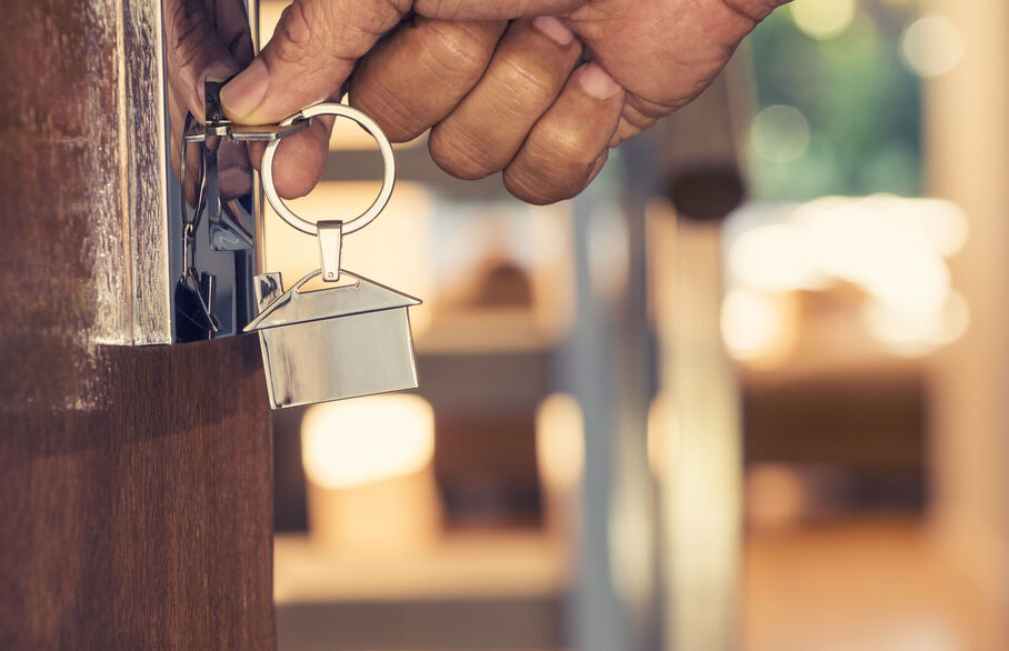 Person opening door with a key