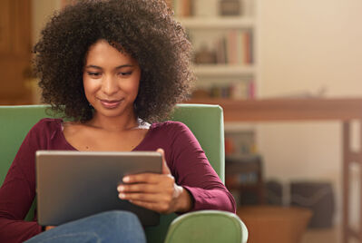 Person sat looking at a tablet computer