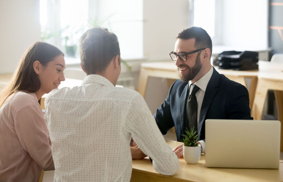 People sat at a desk in a meeting