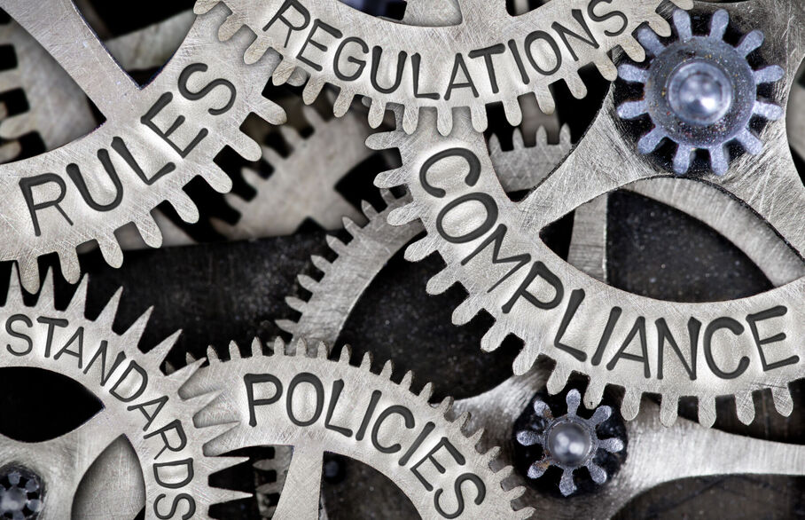 Cogs with the words compliance, regulation, policies on them