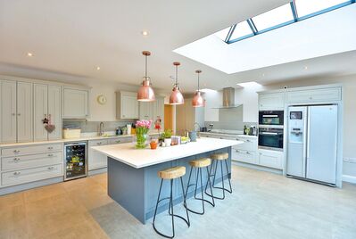 Photo of a modern kitchen wiith island and integrated appliances