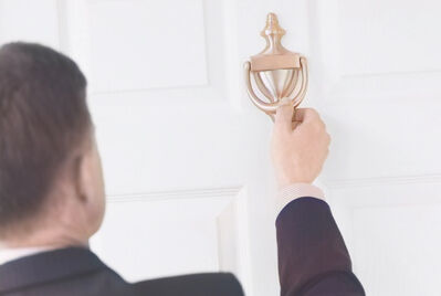 A landlord knocking on a tenant's door