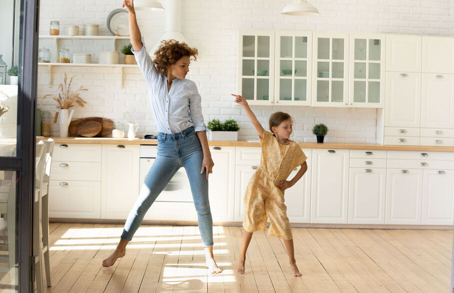 Mum and daughter in the kitchen pointing at the ceiling