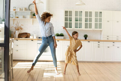 Mum and daughter in the kitchen pointing at the ceiling