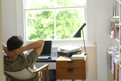 Man with hands behind head