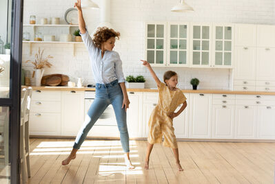 Adult and child jumping in the air