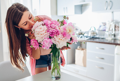 Woman putting out flowers