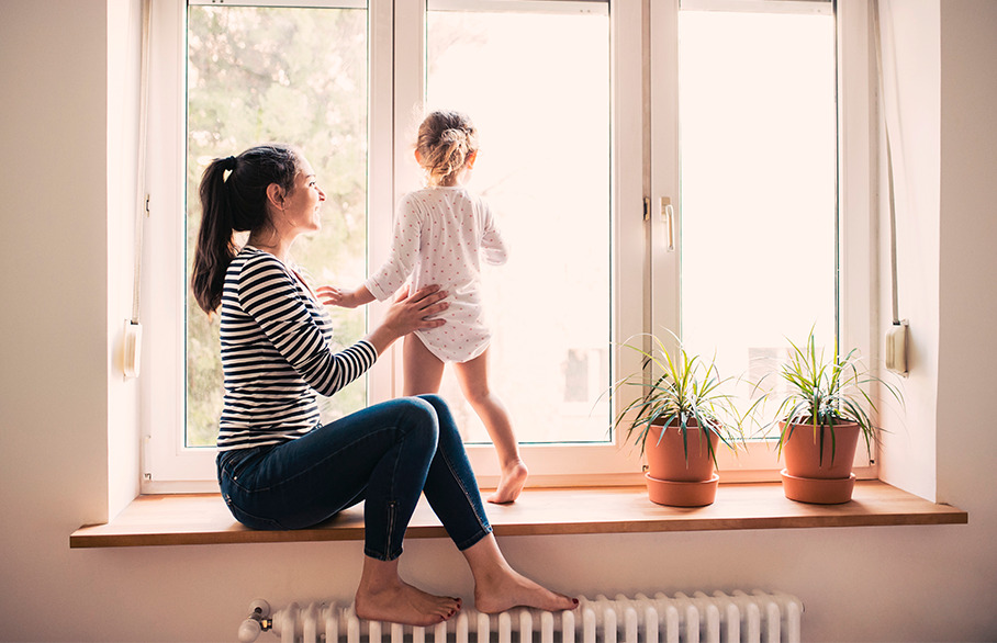 Mother and daughter on windowsill