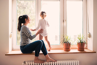 Mother and daughter on windowsill