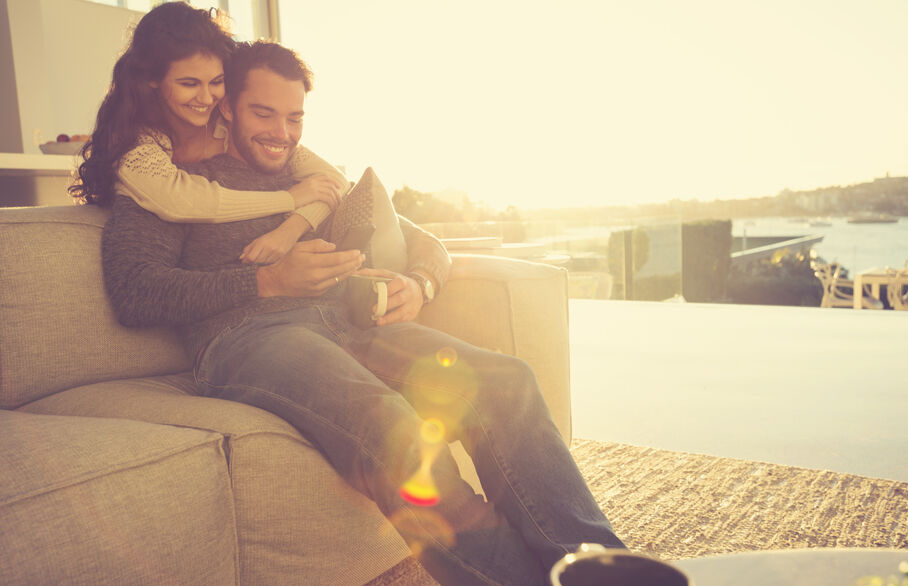 Couple cudddling on the sofa