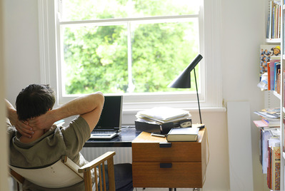 Man at desk looking out window
