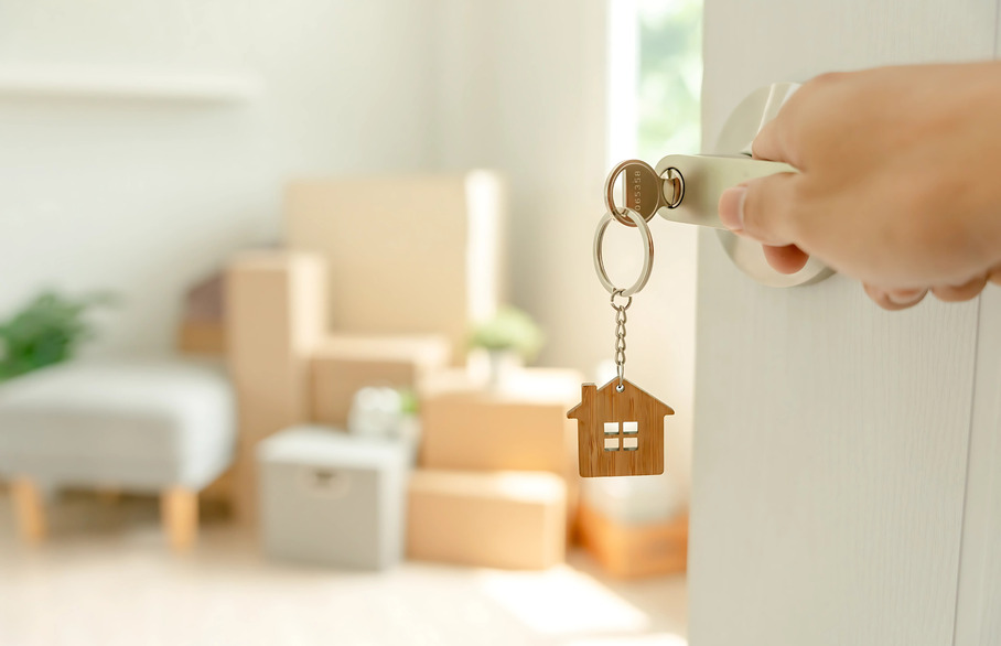 keys to new house with moving boxes on moving day