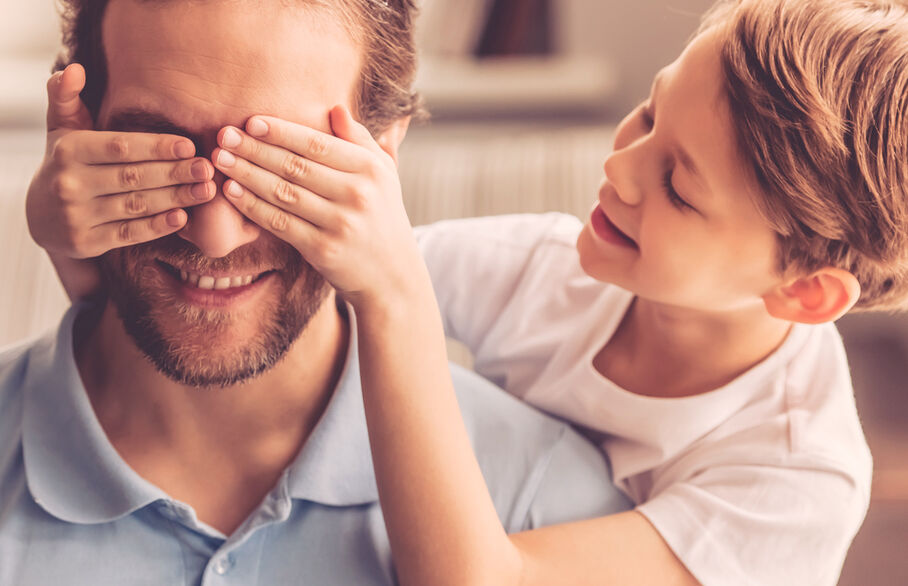Child placing their hands over adults face