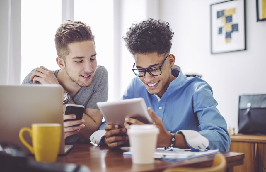 Two people looking at a laptop in the home