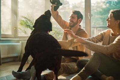 People playing with dog
