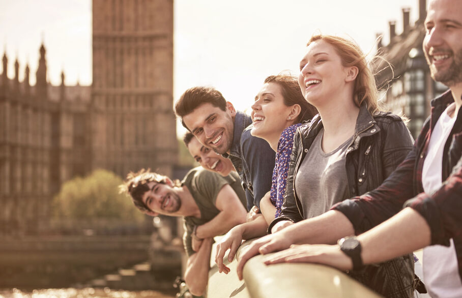 Group of happy smiling people located near Houses of Parliament