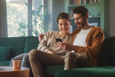 Two people relaxing on a couch together