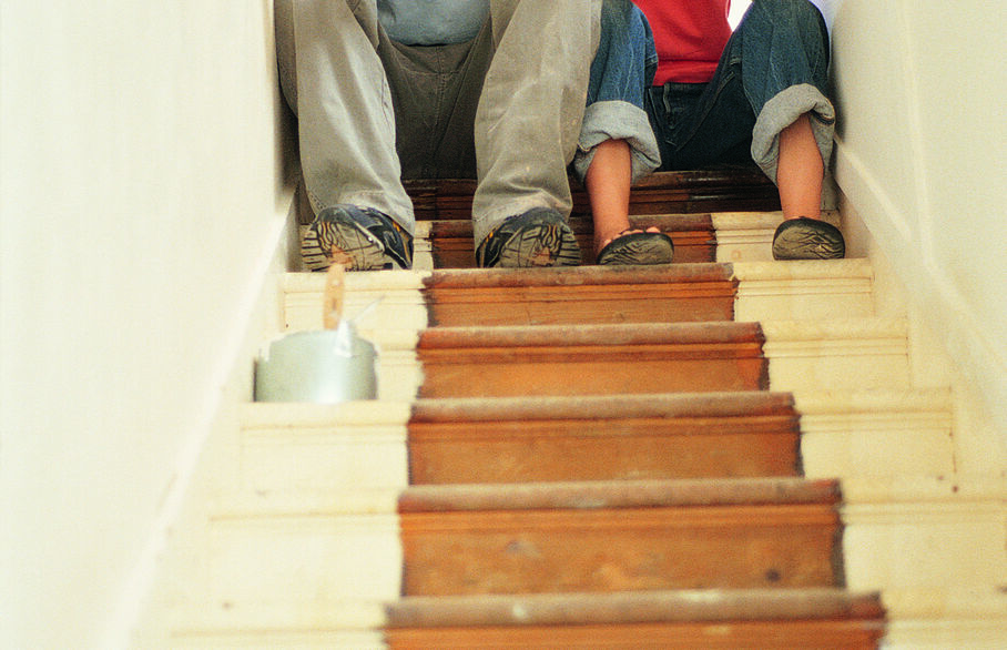 Two people sat at the top of the stairs