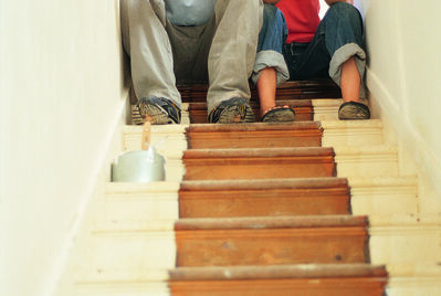 Two people sat at the top of the stairs