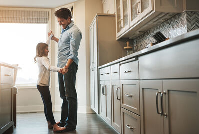 Dad dancing with daughter in the kitchen