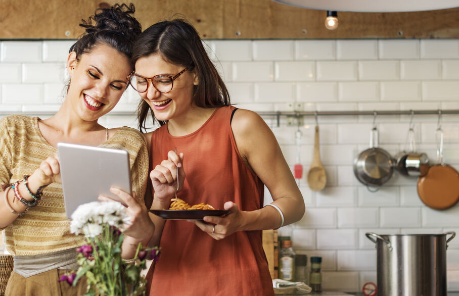 People smiling looking at an tablet