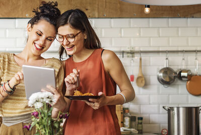 People smiling looking at an tablet