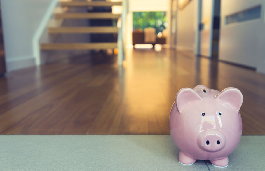 Piggy bank in the foreground with blurred stairs behind