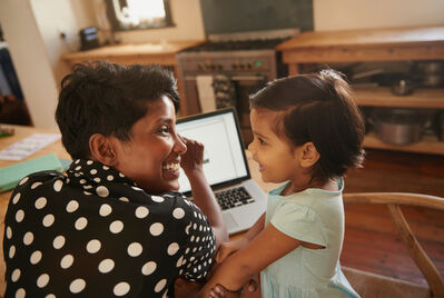 women and child looking at ipad 
