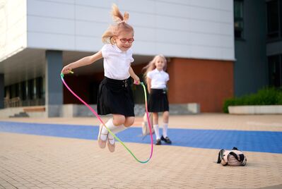 school children jumping 