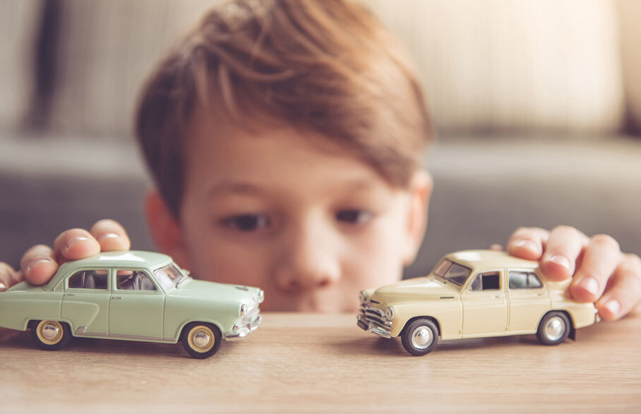 child and toy cars