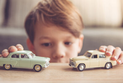 child and toy cars