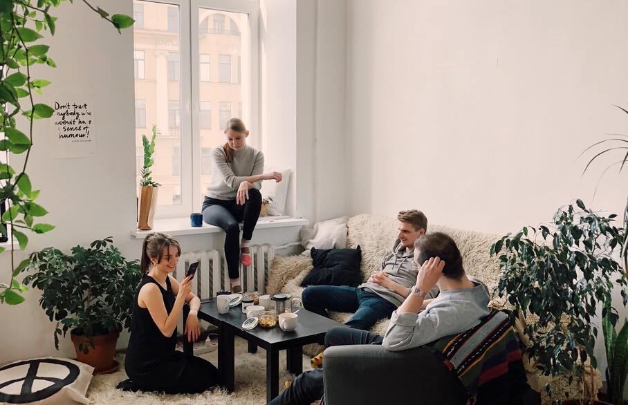 People sat round a table in a living room
