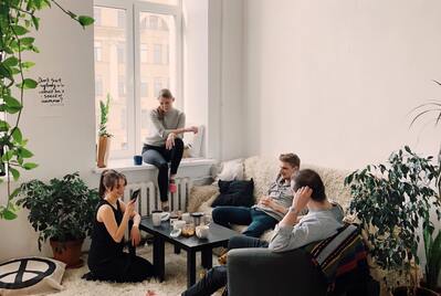 People sat round a table in a living room