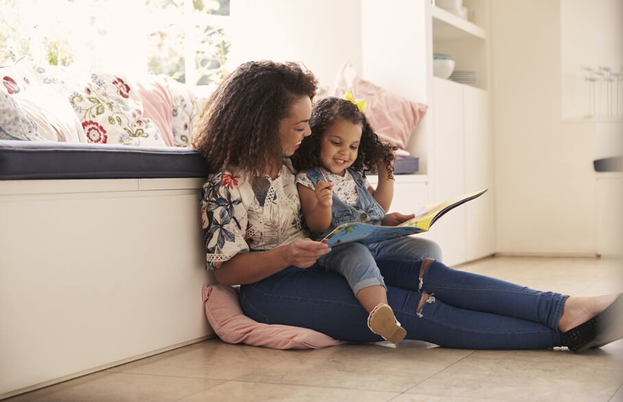 women and kid looking at ipad