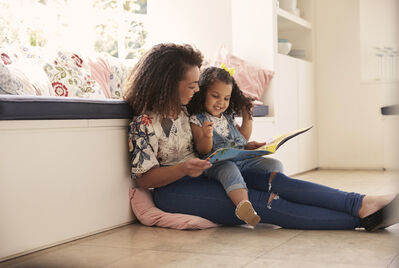 women and kid looking at ipad