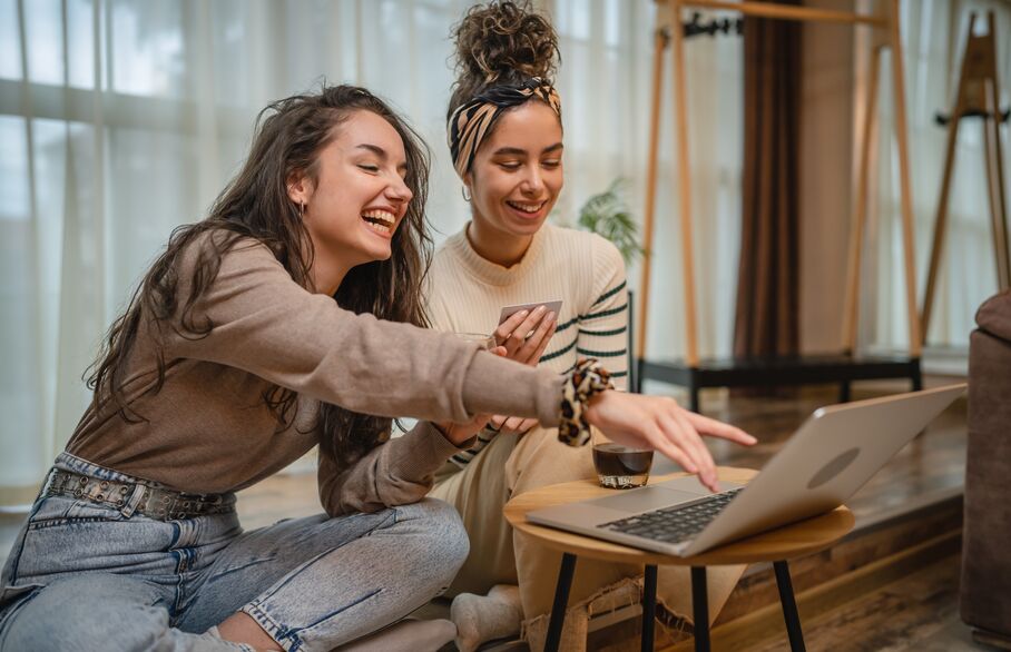 people looking and pointing at a computer