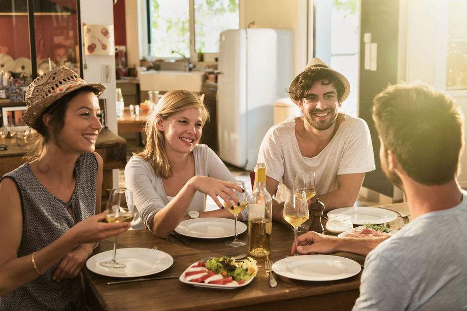Friends sat around the kitchen table
