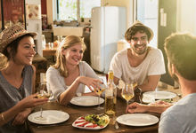 Friends sat around the kitchen table