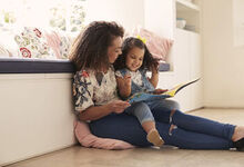 Mother and daughter reading together